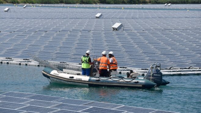 technicians-in-boat-among-floating-solar-panels