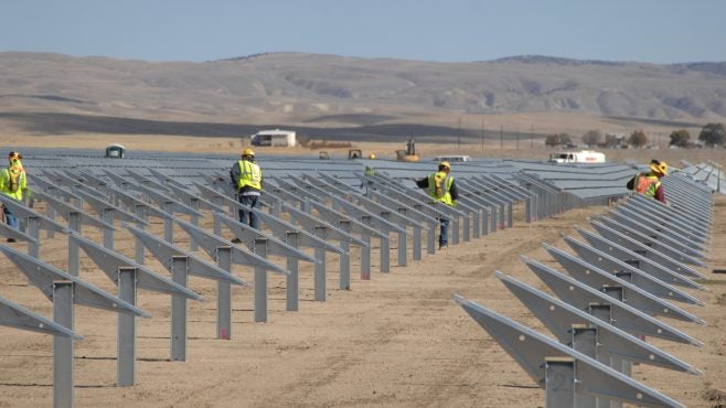 Renewable energy jobs of the future: Workers prepare racking for the Topaz Solar Farm.