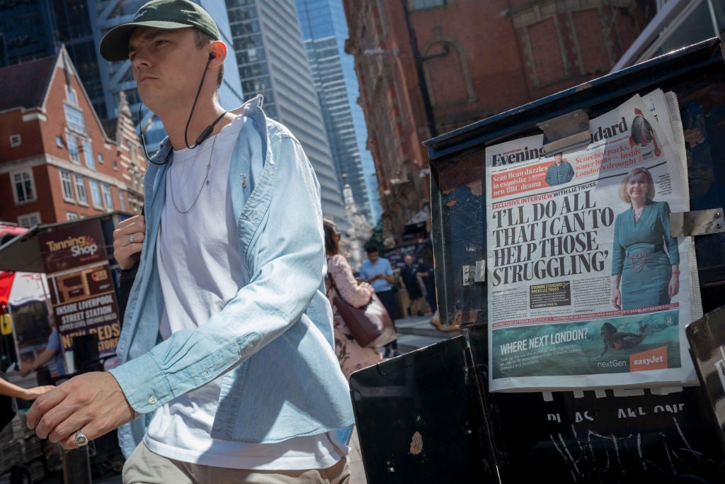 Londoners walk past newspaper headlines that quote Prime Ministerial contender Liz Truss, saying she will do what she can to those struggling during the energy crisis, on 10th August 2022, in London, England.