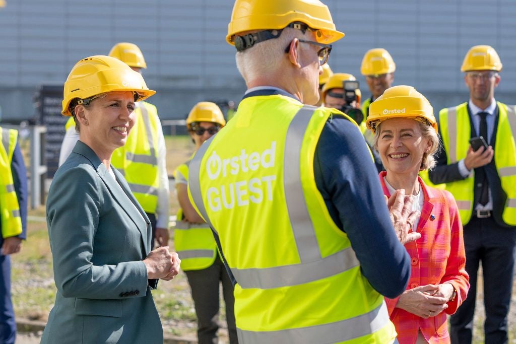 Denmark's Prime Minister Mette Frederiksen (L) and European Commission President Ursula von der Leyen (R) listen to Ørsted CEO Mads Nipper outside the Avedore Power Station in Denmark, on June 17, 2021.