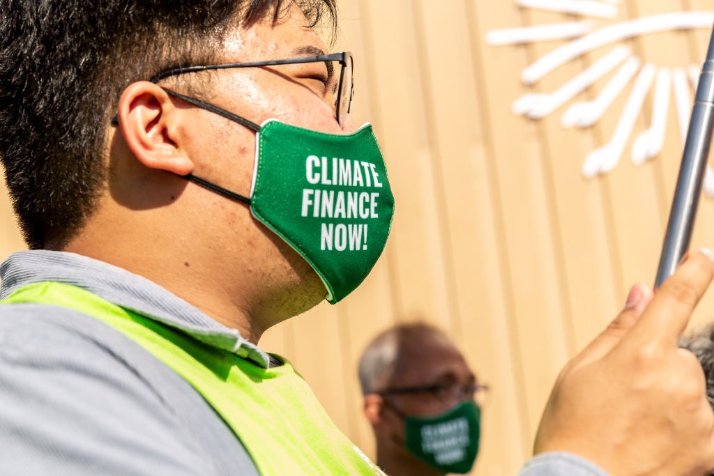 Activists wearing masks with words "Climate Finance Now" protest on the fourth day of the COP27 UN Climate Change Conference (Finance Day), held by UNFCCC in Sharm El-Sheikh International Convention Center.