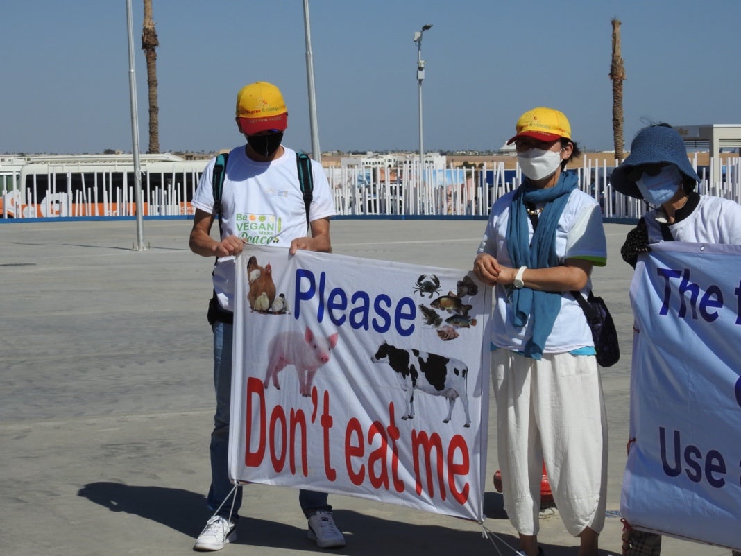 A group of people holding a sign
Description automatically generated with medium confidence