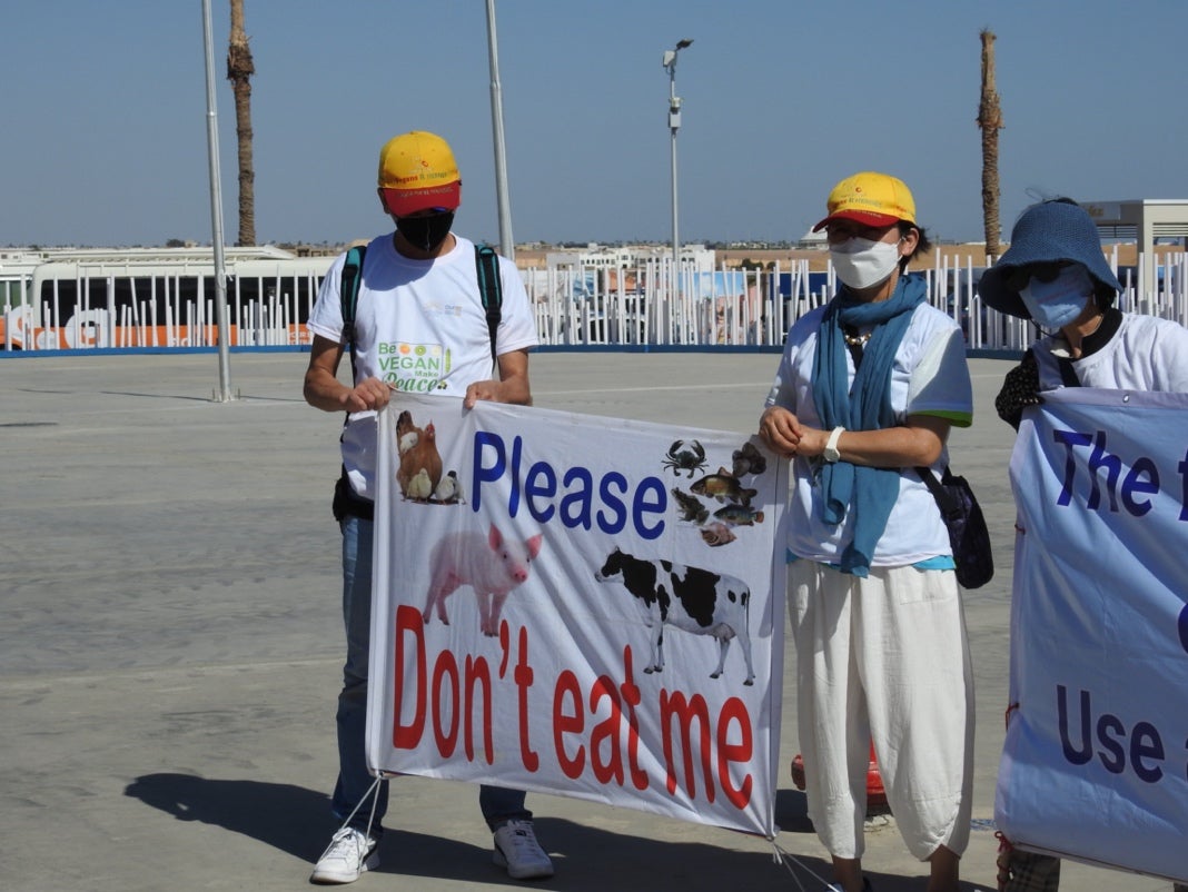 A group of people holding a sign

Description automatically generated with medium confidence